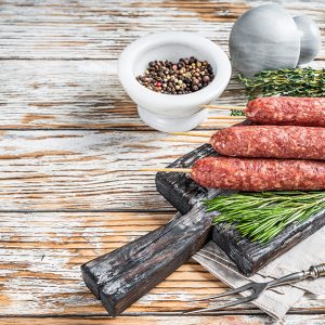 Raw kofta or lula kebabs meat sausages on skewers with herbs. Da